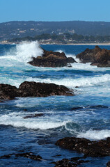 Fototapeta na wymiar waves crash against rocks in Carmel Bay
