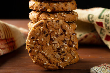 Oatmeal cookies on the table and on a dark background.