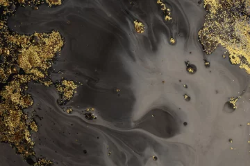  Flow pour oil and acrylic color painting blot. Abstract black and gold glitter texture background. © Liliia