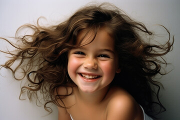 Picture of young girl with big smile on her face. This image captures pure happiness and innocence of childhood. Perfect for any project that requires cheerful and positive vibe