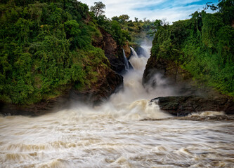 Murchison Falls National Park in Uganda, beautiful water falls on the river Victoria Nile, rainbow above the Uhuru falls and Kabarega falls waterfall in Africa