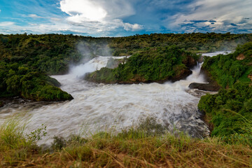 Murchison Falls National Park in Uganda, beautiful water falls on the river Victoria Nile, rainbow above the Uhuru falls and Kabarega falls waterfall in Africa