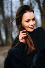A woman with long hair wearing a black coat. The Mysterious Femme Fatale in a Stylish Black Coat...
