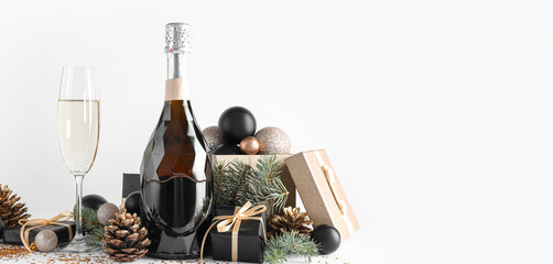 Composition with bottle of champagne, Christmas gifts and beautiful decorations on white background with space for text