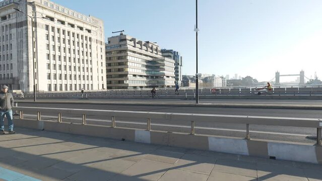 Time lapse. Cars and pedestrians on a busy London Bridge and the Tower bridge seen in the distance.