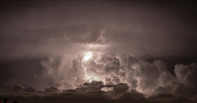 Dramatic dark sky with lightning. Concept on the theme of weather, natural disasters, storms, typhoons, tornadoes, thunderstorms, lightning.