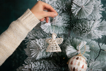 decorating snowy Christmas tree at home