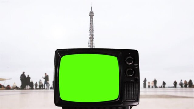 Old Television Turning On Green Screen in Trocadero with the Eiffel Tower in the Background, Paris, France. You can replace green screen with the footage or picture you want with “Keying” effect.