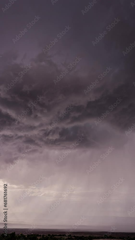 Wall mural vertical dark clouds rotating in the sky in front of monsoon storm in utah moving through the desert