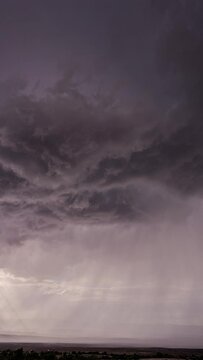 Vertical Dark clouds rotating in the sky in front of monsoon storm in Utah moving through the desert.