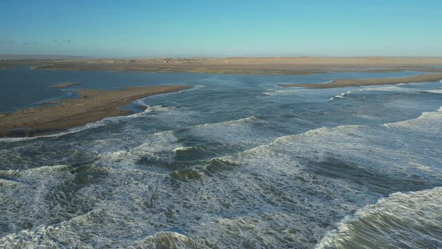 Orbit Orange River Mouth. Long sandbars create narrow opening to turbulent Atlantic Ocean.