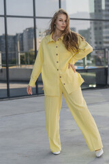 cute girl in a yellow summer outfit. business lady in pantsuit