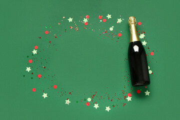 Frame made of champagne bottle with confetti on green background