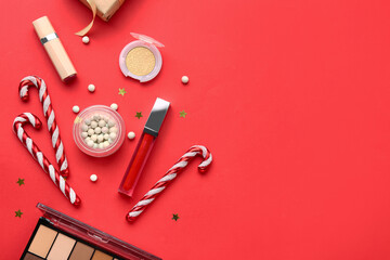 Christmas composition with different makeup products on red background