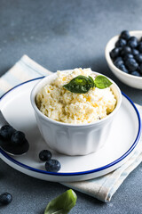 Organic cottage cheese in a ceramic bowl .The concept of home-made food. Selective focus. Horizontal orientation.
