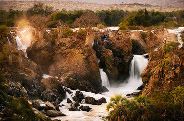 Epupa Falls, Kunene Region, Namibia, in warm sunrise light. Epupa Falls is a series of large...