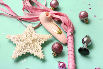 Sex toys and Christmas decor on turquoise background