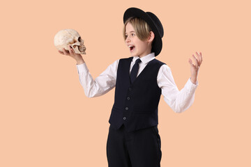 Little actor with skull on beige background