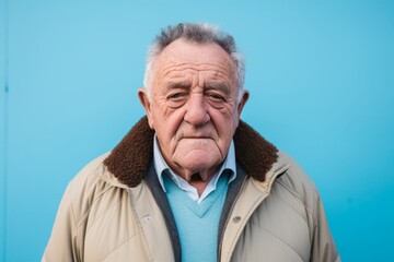 Portrait of a senior man on a blue background. Elderly people.
