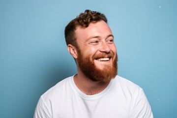 Portrait of a red-bearded man on a blue background