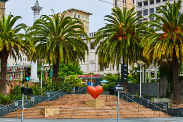 Scenic stairs with red heart in Union Square with tall palm trees San Francisco, CA