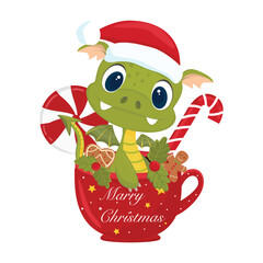 Cute little green dragon in a cup. Sweets in a cup, lollipops, caramel. On a white background. Christmas festive holiday cute mugs. New year drinks decorated with candy.