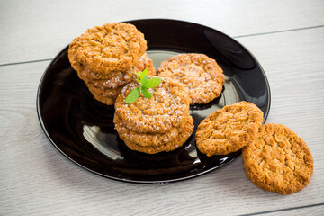 cooked sweet oatmeal cookies on wooden table