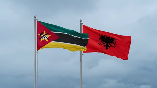 Mozambique flag and Albania flag waving together on cloudy sky, endless seamless loop