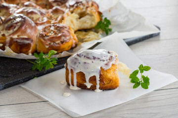 cooked baked sweet cinnabon with cream in baking paper .