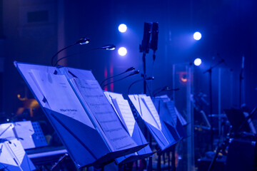 music stands with orchestral notes in the concert hall