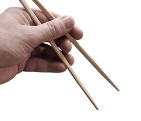 Asian chopsticks held in men hand. No food. No identifiable person. Cut out. PNG