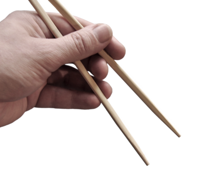 Asian chopsticks held in men hand. No food. No identifiable person. Cut out. PNG