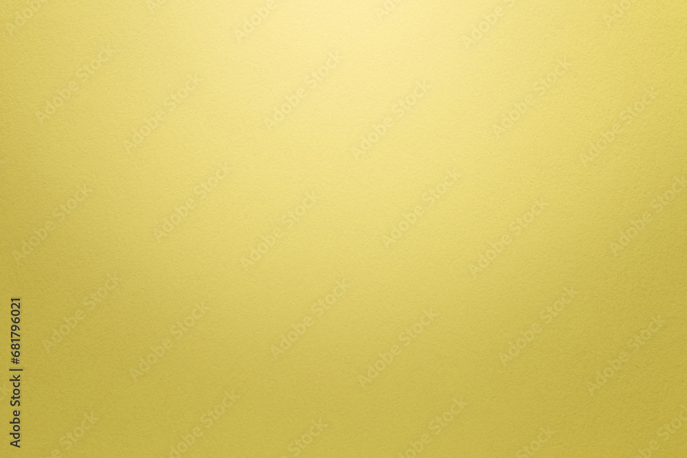 Poster textured bright yellow paper background with light effect. high resolution full frame background wit
