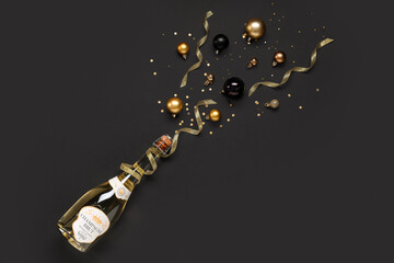 Composition with bottle of champagne and beautiful Christmas decorations on dark background