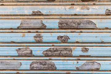 Peeling paint on a metal door in Tunis.