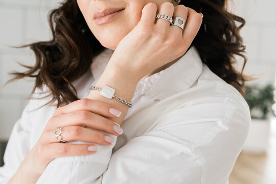 Women Jewelry concept. Woman's hands close up wearing rings and necklace modern accessories elegant lifestyle