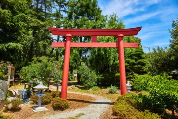 Foto op Aluminium Giant red Torii Gate in Japanese Garden with stone lanterns lining path on sunny day © Nicholas J. Klein