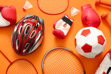 Composition with different sports equipment on orange background