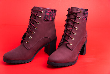 Autumn and winter women's red ankle boots on red background