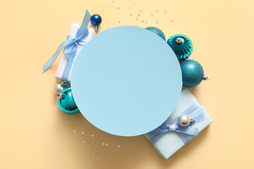 Round blank card with blue Christmas decor on light yellow background