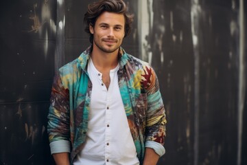 Portrait of a handsome young man in a shirt and colorful scarf
