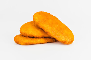 Chicken Breaded Fillet.Fast food. Breaded Chicken Inner Fillet on a White Background,Chicken Breaded Raw Meat. Fast cooking. Breaded chicken nuggets. Homemade food at home.