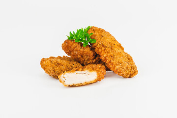 Breaded Chicken Inner Fillet, Chicken Breaded Raw Meat. Fast cooking.Breaded Chicken nuggets Fillet with salad on a White Background,food at home. Fast homemade food.Chicken breaded schnitzels.