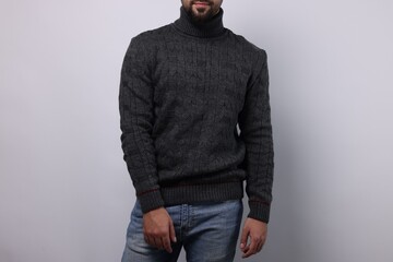 Man in stylish sweater on white background, closeup