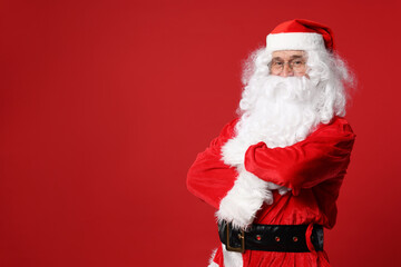Merry Christmas. Santa Claus posing on red background, space for text