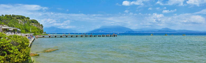 Beautiful panoramic view of the Lido delle Bionde beach on Lake Garda in Sirmione, province of Brescia, Italy.