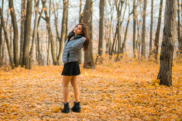 Fototapeta premium Rear view portrait of diversity young beautiful confident Indian Asian woman in fall outdoor. Happy and natural smiling female. Generation z and gen z youth concept