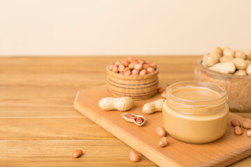 Jar of peanut butter on wooden table
