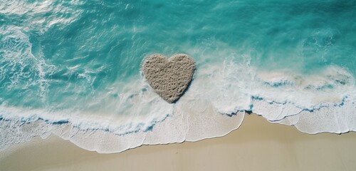 An aerial view of a heart drawn in the sand of a secluded beach, with the waves of the turquoise ocean gently erasing the edges, capturing a moment of tranquility.