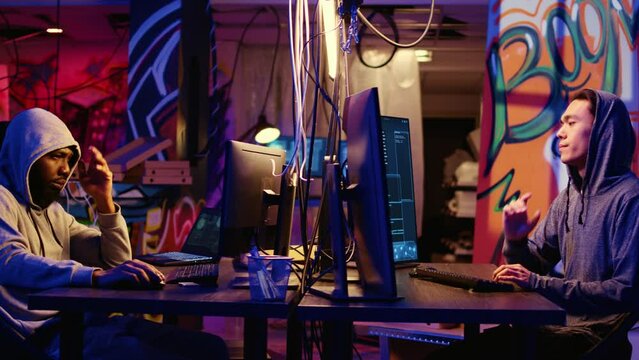 Experienced hacker group members sneaking malware virus on unaware victims computers, stealing sensitive and private information, selling it on internet to highest bidder